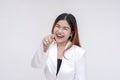 A playful and happy young woman pointing while laughing at the camera. Isolated on a white background Royalty Free Stock Photo