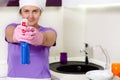 Playful housewife taking aim with the detergent Royalty Free Stock Photo