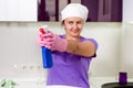 Playful housewife taking aim with the detergent Royalty Free Stock Photo