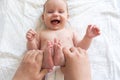 Playful interactions with baby small feet. Concept of the joys of motherhood Royalty Free Stock Photo