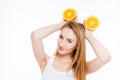 Playful joyful woman holding two orange halves above her head Royalty Free Stock Photo