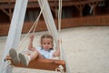 Playful kid swinging swing. Joyful little girl play having fun playground summertime