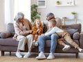 Playful kids and grandmother with grandfather tickling each other while spending time together on weekend Royalty Free Stock Photo