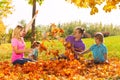 Playful kids and parents throw leaves in the air Royalty Free Stock Photo