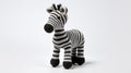 Playful Knitted Zebra Toy On White Background