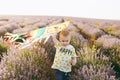 Playful little cute child baby boy walk on purple lavender flower meadow field, run, have fun, play with colorful kite Royalty Free Stock Photo