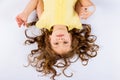 Playful little girl in yellow dress barefoot