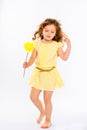 Playful little girl in yellow dress
