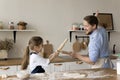 Playful loving dad and kid playing battle at kitchen table Royalty Free Stock Photo