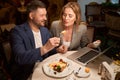 Playful man feeding his girlfriend with tasty lunch, flirt Royalty Free Stock Photo