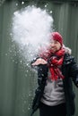 Playful middle age man in winter clothes throwing cloud of snow Royalty Free Stock Photo