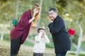 Playful Mixedrace Parents With Gifts for Young Boy Hiding Eyes Royalty Free Stock Photo