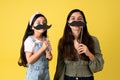 Playful mom and daughter with mustaches