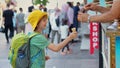 A playful moment unfolds as a boy anticipates the taste of creamy Turkish ice cream, only to be met with the