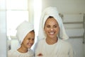 Playful mother and daughter doing a hygiene, skincare routine together in the bathroom. Mom teaching her adorable child Royalty Free Stock Photo