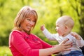 Playful mother having fun with her baby in nature Royalty Free Stock Photo