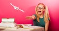 Playful, naughty schoolgirl with big eyeglasses playing with pap Royalty Free Stock Photo