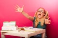 Playful, naughty schoolgirl with big eyeglasses playing with pap Royalty Free Stock Photo