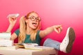 Playful, naughty schoolgirl with big eyeglasses throwing paper a Royalty Free Stock Photo