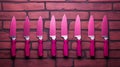 Playful Pink Kitchen Knives On Brick Wall: Conceptual Photography