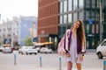 Playful portrait of pretty young woman, having fun at the street.