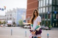 Playful portrait of pretty young woman, having fun at the street.