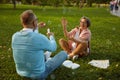 Playful senior couple blowing soap bubbles while rest in park Royalty Free Stock Photo