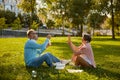 Playful senior couple blowing soap bubbles while rest in park Royalty Free Stock Photo