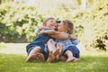 Playful siblings having fun on a green lawn