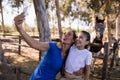 Playful siblings taking selfie