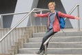 Playful student sliding down handrail on stairway Royalty Free Stock Photo