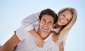 Playful summer romance. A handsome young man giving his girlfriend a piggyback ride outside. Royalty Free Stock Photo