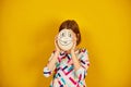 Playful teenager girl covering her face of Ostrich egg with funny face Royalty Free Stock Photo