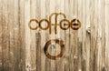 Playful Lettering Coffee with a Simple Stylized Coffee Cup on Wooden Background Royalty Free Stock Photo