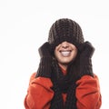 Playful woman hiding under a winter hat