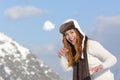 Playful woman throwing a snow ball in winter on holidays