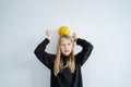 Playful 10yo boy posing for a photo, balancing a mini basketball on his head