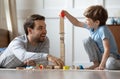 Happy young dad play build blocks with small son Royalty Free Stock Photo
