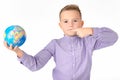 Playful young caucasian school boy holding a globe on white studio background.Boy shows at globe laughing Royalty Free Stock Photo