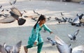 Playful young child with pigeons