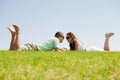 Playful young couple laying on a grass lawn Royalty Free Stock Photo