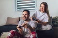 Young couple playing video games in their living room Royalty Free Stock Photo