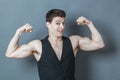 Playful young man flexing muscles showing male power