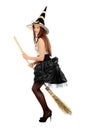 Playful young woman with a besom Royalty Free Stock Photo