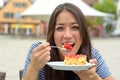 Playful young woman enjoying a slice of cake Royalty Free Stock Photo