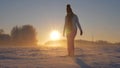 Woman In Winter Field At Sunset Kicked Snow And Glittering Snowflakes And Frost