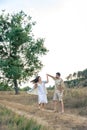 Playful and youthful adult man and woman having fun together in the meadow. Royalty Free Stock Photo