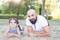 Playfull daughter child with bald man father outdoor