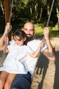 Playfull daughter child with bald man father outdoor