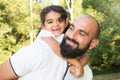 Playfull daughter child with bald man father outdoor